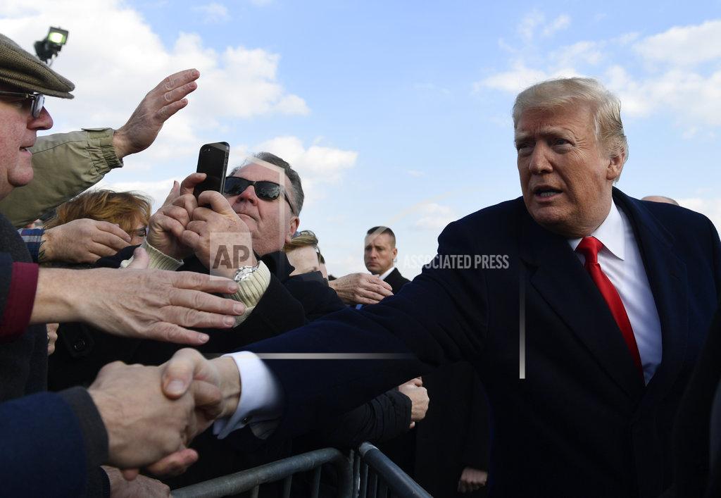 Susan Walsh President Donald Trump greets people after arriving via Air Force One at Philadelphia International Airport in Philadelphia, Saturday, Dec. 8, 2018. Trump is attending the Army-Navy football game. (AP Photo/Susan Walsh)