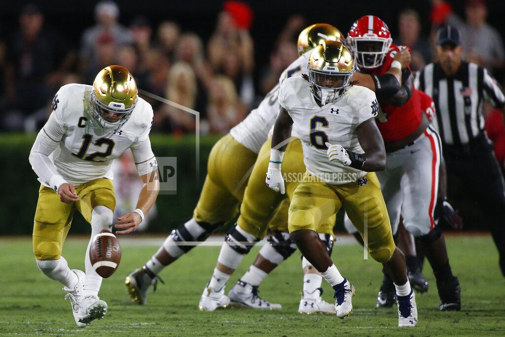 Joshua L. Jones Notre Dame quarterback Ian Book (12) and Notre Dame running back Tony Jones Jr. (6) run after a lose ball in the first half of a NCAA football game between Georgia and Notre Dame in Athens, Ga., on Saturday, Sept. 21, 2019. (Joshua L. Jones/Athens Banner-Herald via AP)