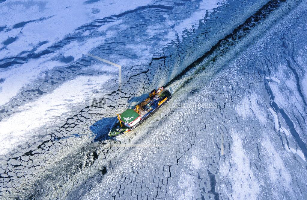 Jens Buettner The Goermitz is underway as an icebreaker on the northern Peene River between the mainland and the island of Usedom near Karlshagen, Germany, Friday, Feb. 12, 2021. The freezing weather of the last few days has caused a layer of ice on the coastal waters of the Baltic Sea. (Jens Buettner/dpa via AP)