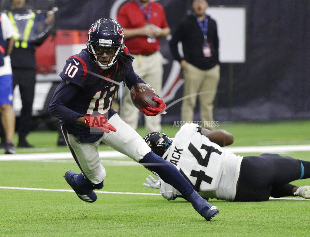 David J. Phillip FILE - In this Dec. 30, 2018, file photo, Houston Texans wide receiver DeAndre Hopkins (10) runs past Jacksonville Jaguars middle linebacker Myles Jack (44) after making a catch during the first half of an NFL football game in Houston. The Texans have placed Hopkins on the physically unable to perform list. (AP Photo/David J. Phillip, File)