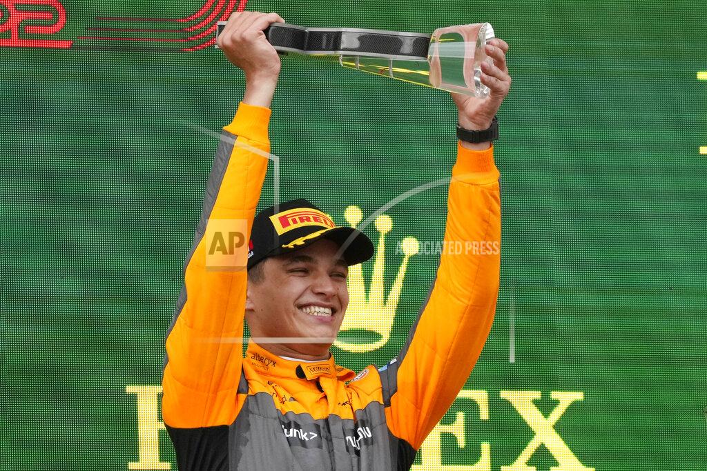 Luca Bruno McLaren driver Lando Norris of Britain celebrates on the podium his third place at the Emilia Romagna Formula One Grand Prix, at the Enzo and Dino Ferrari racetrack, in Imola, Italy, Sunday, April 24, 2022. (AP Photo/Luca Bruno)