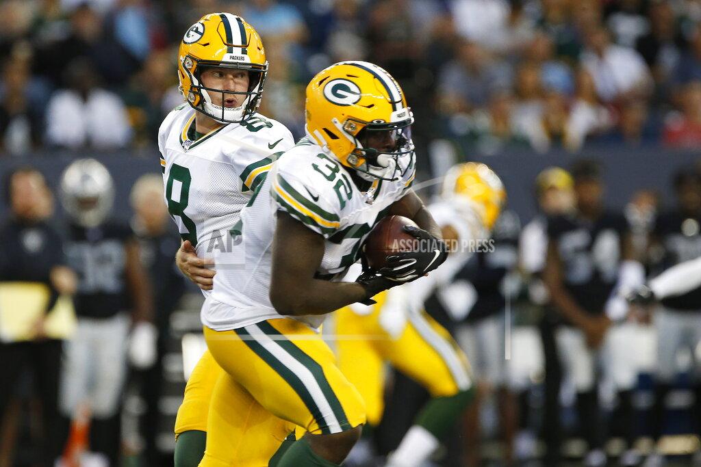 John Woods Green Bay Packers quarterback Tim Boyle (8) hands off to Tra Carson (32) during the first half of an NFL preseason football game against the Oakland Raiders on Thursday, Aug. 22, 2019, in Winnipeg, Manitoba. (John Woods/The Canadian Press via AP)