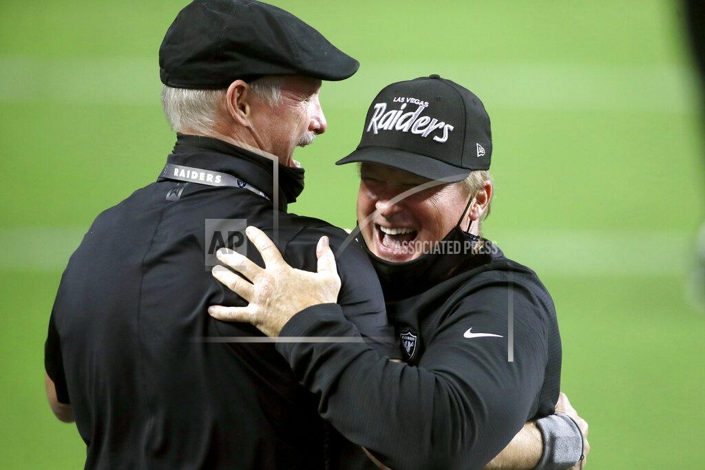 Isaac Brekken Las Vegas Raiders GM Mike Mayock, left, embraces head coach Jon Gruden after defeating the New Orleans Saints in an NFL football game, Monday, Sept. 21, 2020, in Las Vegas. (AP Photo/Isaac Brekken)