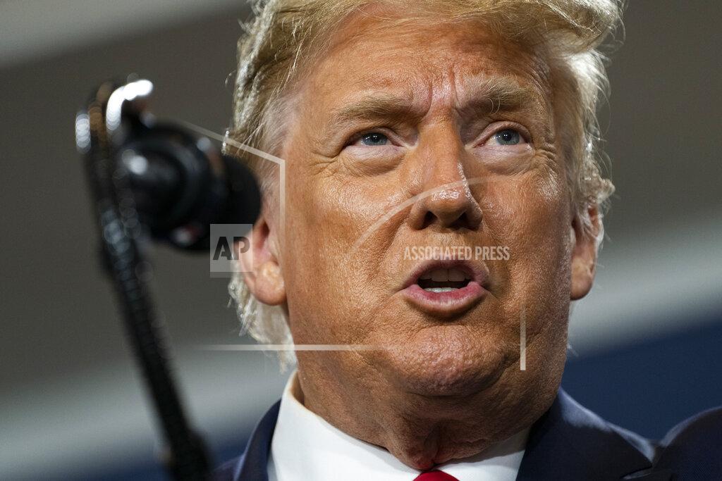 Supporters of President Donald Trump listen to him speak during an event on