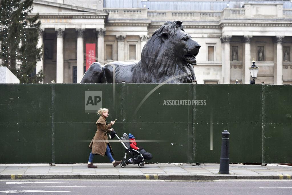 Dominic Lipinski Fencing around the lion statues in Trafalgar Square, London, ahead of New Year's Eve celebrations, Thursday Dec. 31, 2020. The British government has extended its toughest coronavirus restrictions to more than three-quarters of England’s population, saying a fast-spreading variant of the virus has reached most of the country. The move will severely curtail New Year’s Eve celebrations in parts of England that are home to 44 million people, or 78% of the population. People are advised to stay home, nonessential shops are shut and restaurants and bars can only offer takeout. (Dominic Lipinski/PA via AP)