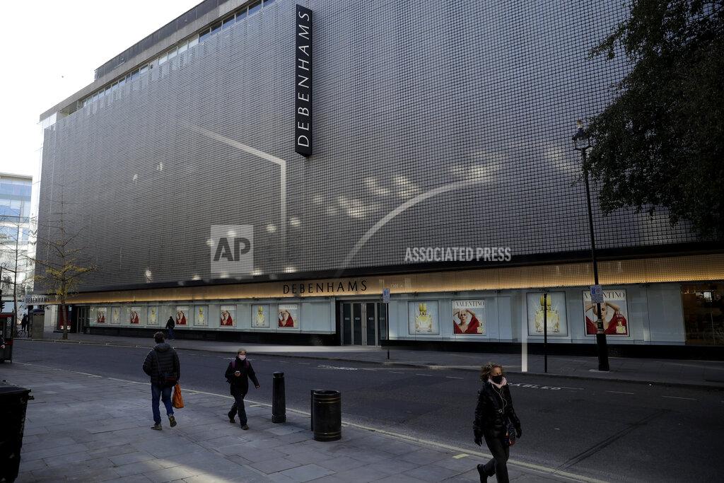 Matt Dunham People wearing face masks walk past the Debenhams flagship department store on a side street off Oxford Street, during England's second coronavirus lockdown in London, Tuesday, Dec. 1, 2020. In another dark day for the British retailing industry, Debenhams said Tuesday it will start liquidating its business after a potential buyer of the company pulled out, a move that looks like it will cost 12,000 workers their jobs. (AP Photo/Matt Dunham)