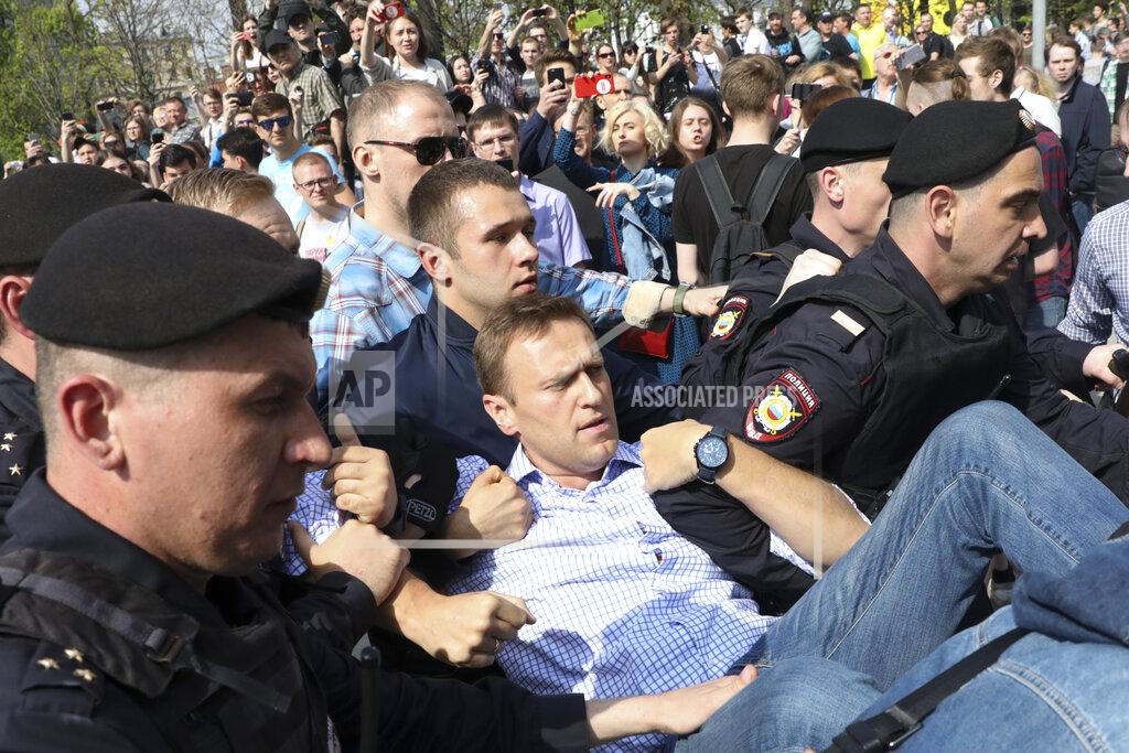 Uncredited FILE - In this May 5, 2018, file photo, Russian police carry opposition leader Alexei Navalny, center, from a demonstration against President Vladimir Putin in Pushkin Square in Moscow, Russia. Navalny is an anti-corruption campaigner and the Kremlin’s fiercest critic. Frequently arrested, he has served multiple stints in jail for charges relating to leading protests. (AP Photo/File)