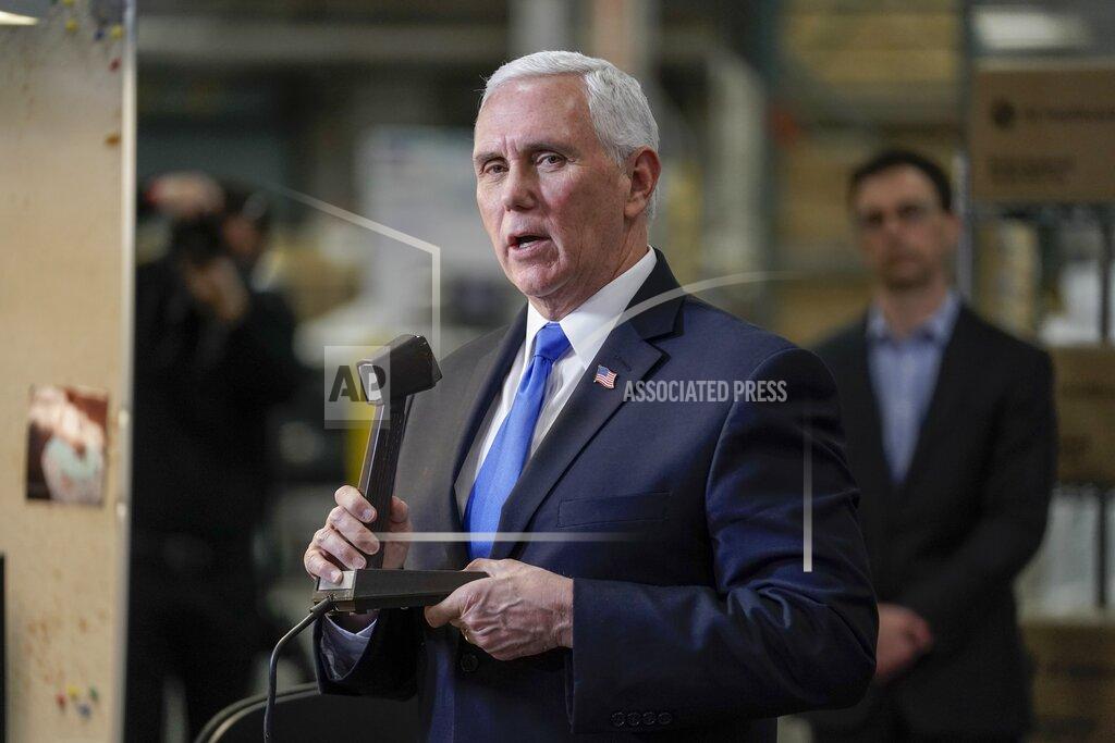 Morry Gash Vice President Mike Pence talks on a PA to workers at the GE Healthcare manufacturing facility Tuesday April 21, 2020, in Madison, Wis. (AP Photo/Morry Gash)