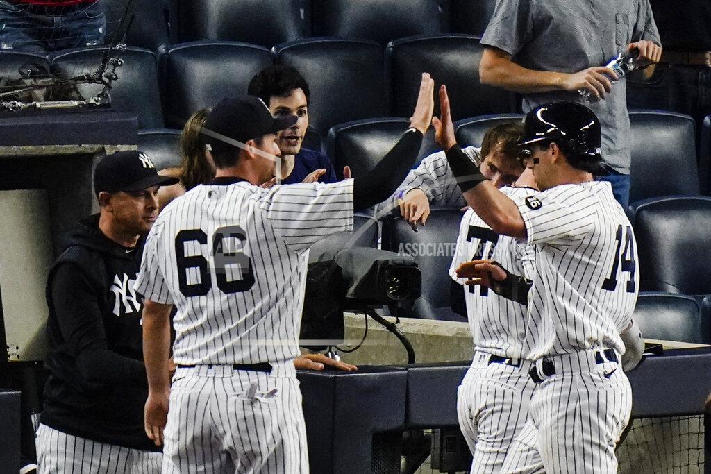 Frank Franklin Ii New York Yankees' Tyler Wade (14) celebrates with teammates after scoring on a sacrifice fly ball by Aaron Judge during the fifth inning of the second game of a baseball doubleheader Thursday, May 27, 2021, in New York. The Yankees won 5-3. (AP Photo/Frank Franklin II)