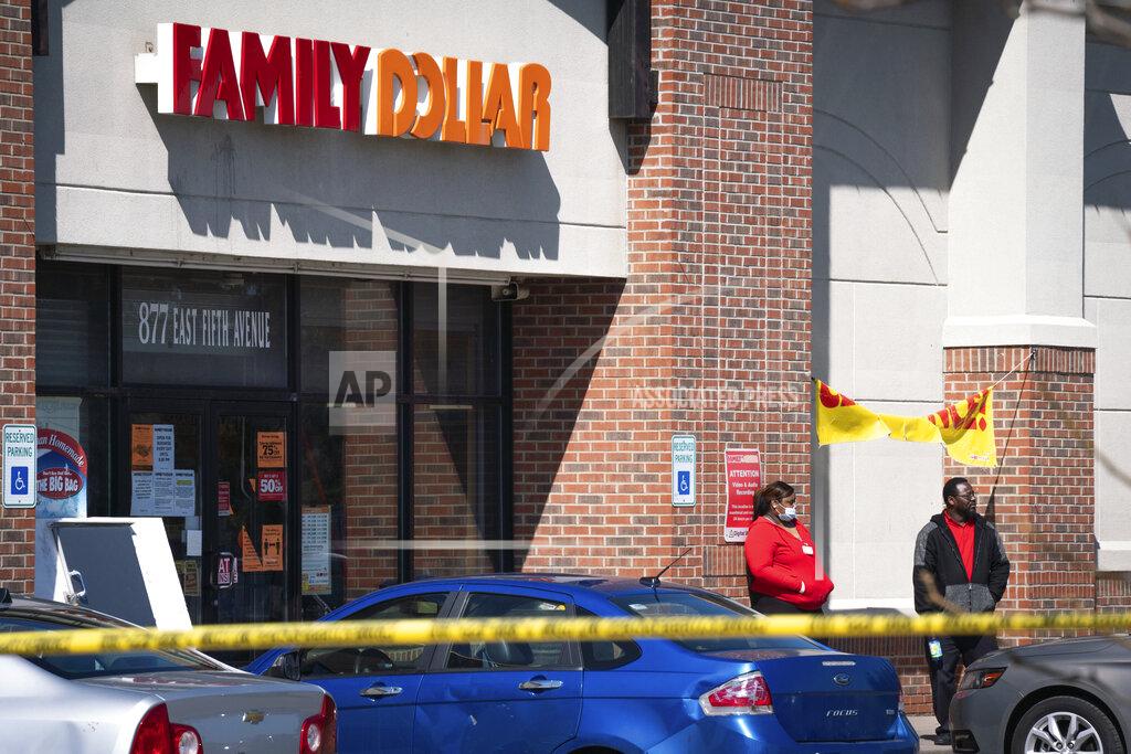 Sarahbeth Maney In this Friday, May 1, 2020 photo, employees stand outside the Family Dollar as police investigate a shooting that took place at the store in Flint, Mich. (Sarahbeth Maney/The Flint Journal via AP)