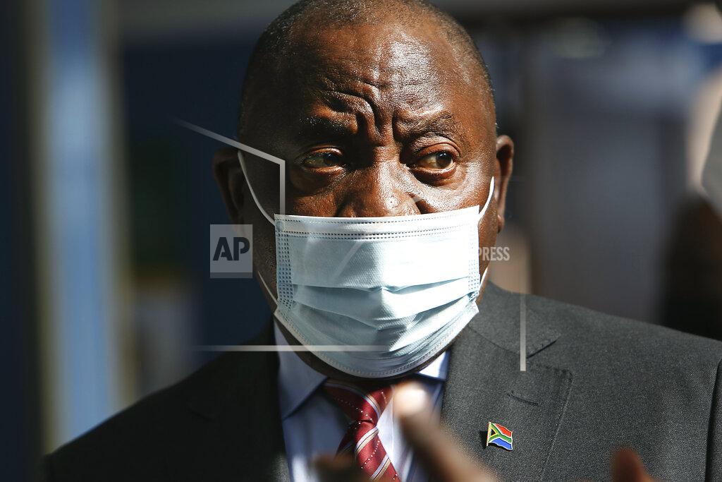 Uncredited South African President Cyril Ramaphosa wears a face mask on a visit to a COVID-19 vaccination centre in Tembisa, South Africa, Thursday, July 29, 2021. Hitting its stride after a faltering start, South Africa’s mass vaccination campaign gave jabs to 220,000 people a day last week and is accelerating toward the goal of 300,000 per day. With large deliveries of doses arriving and some vaccines being assembled here, South Africa appears on track to inoculate about 35 million of its 60 million people by the end of the year. (AP Photo)