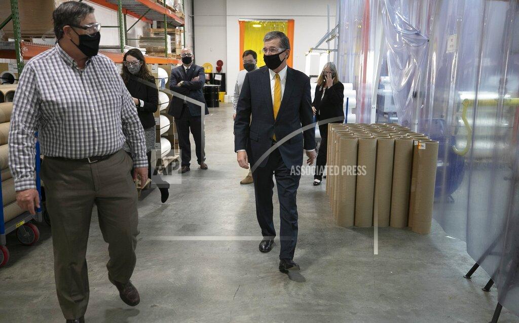 Robert Willett North Carolina Roy Cooper takes a tour of Bright View Technologies on Thursday, Nov. 19, 2020 in Durham, N.C. Bright View Technologies produces optical management products and began producing face shields when the COVID-19 pandemic started. (Robert Willett/The News & Observer via AP)