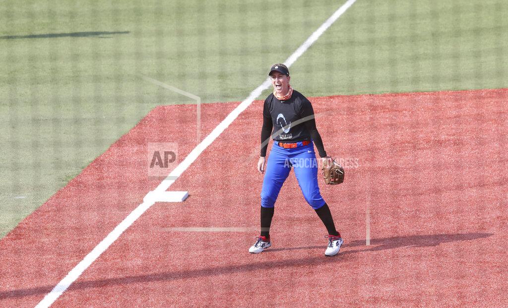 Infielder Sam Fischer reacts during Athletes Unlimited practice on Wednesday, Sept. 16, 2020, in Rosemont, Illinois. Elite players are living life in a bubble to prevent the spread of COVID during the inaugural Athletes Unlimited softball season. When they're not at the ballpark or an indoor facility across the parking lot, they are at their hotel or apartment. Everywhere else is off limits to them. (AP Photo/Teresa Crawford)