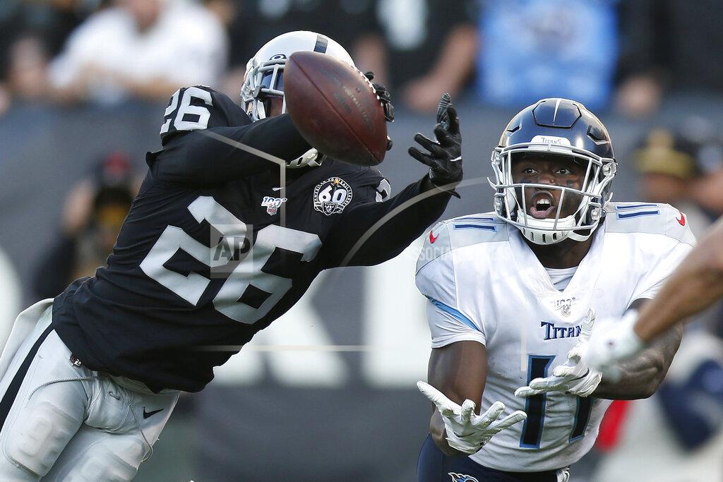 D. Ross Cameron Oakland Raiders cornerback Nevin Lawson (26) breaks up a pass intended fo Tennessee Titans wide receiver A.J. Brown (11) during the second half of an NFL football game in Oakland, Calif., Sunday, Dec. 8, 2019. (AP Photo/D. Ross Cameron)