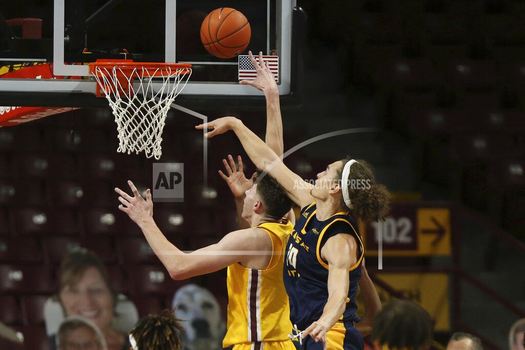 Stacy Bengs UMKC forward Josiah Allick, right, fouls Minnesota center Liam Robbins during an NCAA college basketball game Thursday, Dec. 10, 2020, in Minneapolis. (AP Photo/Stacy Bengs)