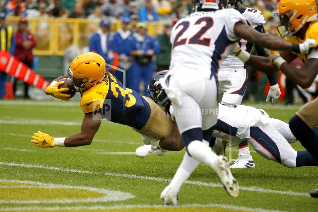Matt Ludtke Green Bay Packers running back Aaron Jones, left, scores past Denver Broncos defensive back Kareem Jackson (22) during the first half of an NFL football game Sunday, Sept. 22, 2019, in Green Bay, Wis. (AP Photo/Matt Ludtke)