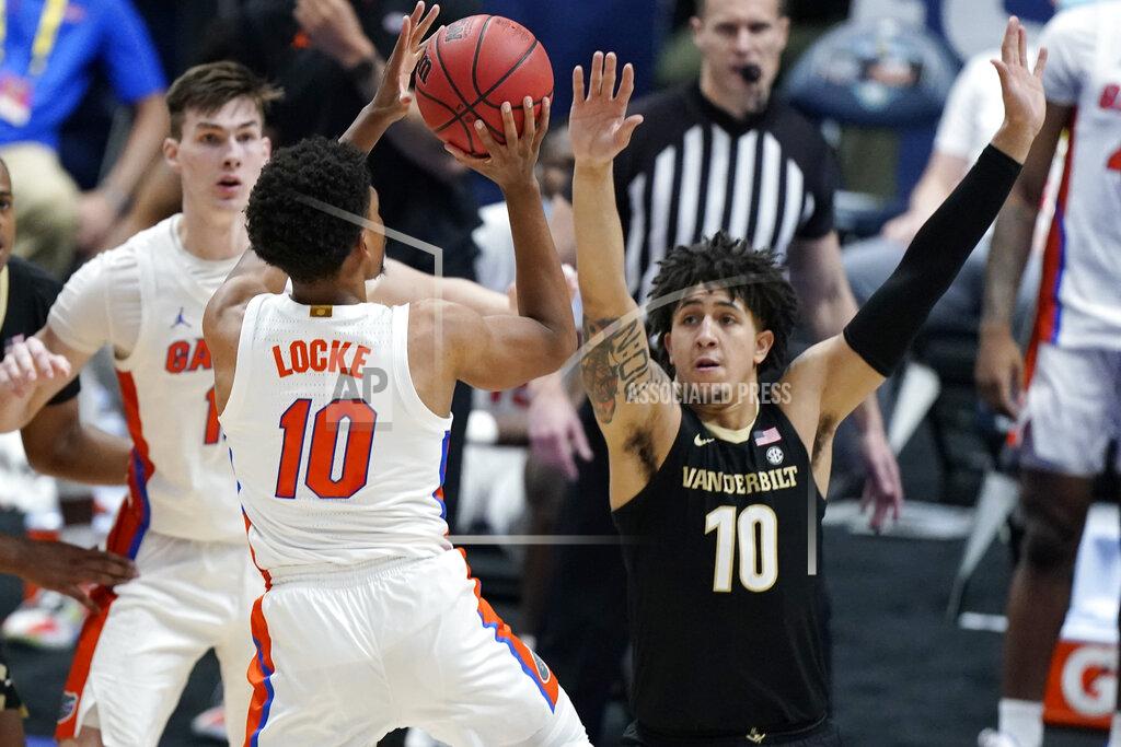 Mark Humphrey Florida's Noah Locke shoots against Vanderbilt's Myles Stute, right, in the second half of an NCAA college basketball game in the Southeastern Conference Tournament Thursday, March 11, 2021, in Nashville, Tenn. (AP Photo/Mark Humphrey)