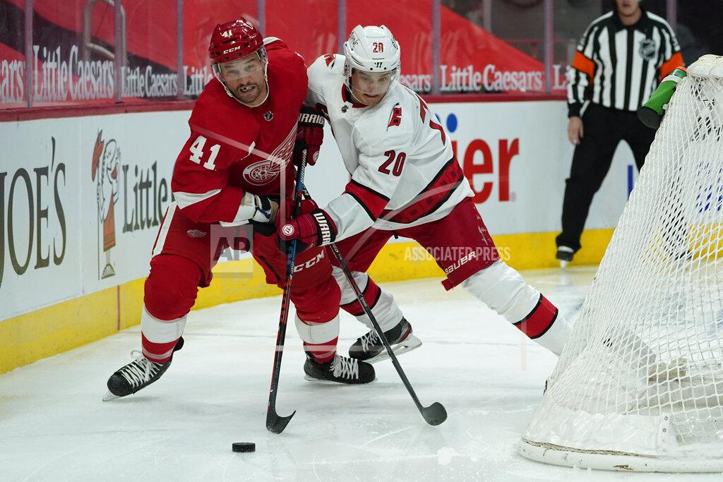 Paul Sancya Detroit Red Wings center Luke Glendening (41) and Carolina Hurricanes right wing Sebastian Aho (20) battle for the puck in the second period of an NHL hockey game Thursday, Jan. 14, 2021, in Detroit. (AP Photo/Paul Sancya)