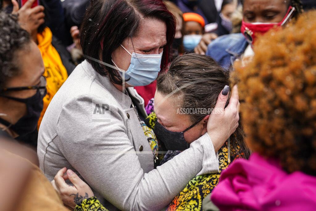 John Minchillo Courtney Ross, girlfriend of the deceased George Floyd, left, hugs Katie Wright, mother of the deceased Daunte Wright, right, before a news conference, Tuesday, April 13, 2021, in Minneapolis. Daunte Wright, 20, was shot and killed by police Sunday after a traffic stop in Brooklyn Center, Minn. (AP Photo/John Minchillo)