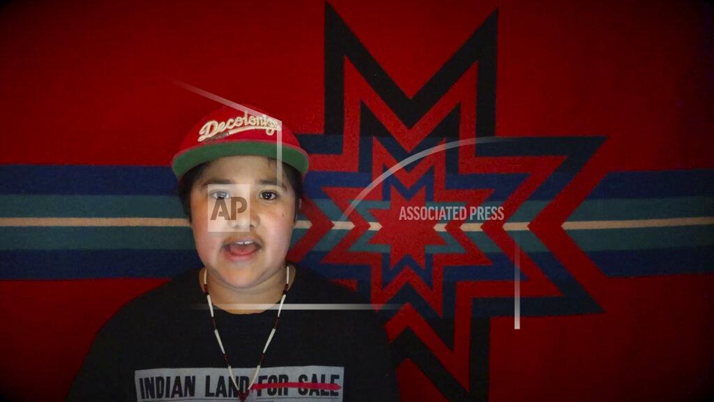 Gillian Flaccus In this image from video, Ishikiihara E-kor sings a rap song about the COVID-19 coronavirus pandemic in Orleans, Calif. “Stay away, man, six feet at least. Social distancing, it’s a thing that could save us. What? Like 5,000 of us left, Karuk tribe, man, that’s it.” He celebrated his recent 11th birthday with relatives on a video conference call. (AP Photo/Gillian Flaccus)