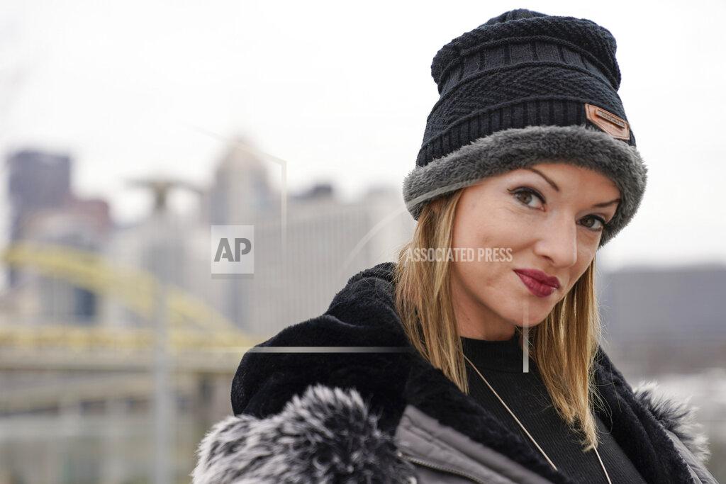 In this Monday, Feb. 8, 2021, photo, Allissa Star poses for a photograph along the north shore of the Allegheny River in Pittsburgh. Starr worked about a week every month at a brothel in Pahrump, Nev., outside of Las Vegas. Then the pandemic led to the shuttering of Nevada's licensed bordellos, the only place where prostitution is legal in the state, and they have remained closed since March, leaving sex workers like Starr struggling to pay the bills and turning to alternatives like "virtual" dates. (AP Photo/Keith Srakocic)