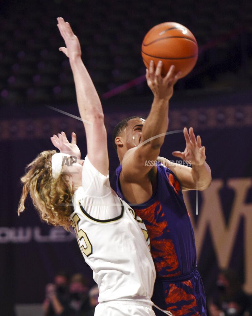 Walt Unks Clemson's Nick Honor, right, drives the lane past Wake Forest's Carter Whitt during the first half of an NCAA college basketball game, Wednesday, Feb. 24, 2021 at Joel Coliseum in Winston-Salem, N.C. (Walt Unks/The Winston-Salem Journal via AP, Pool)