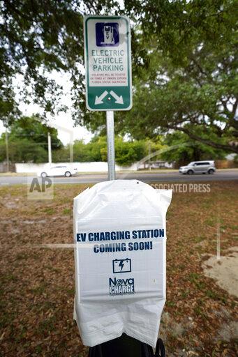 John Raoux A parking area with charging stations for electric vehicles at a public park is seen Thursday, April 1, 2021, in Orlando, Fla. As part of an infrastructure proposal by the Biden administration, $174 billion will be set aside to build 500,000 electric vehicle charging stations, electrify 20% of school buses and electrify the federal fleet, including U.S. Postal Service vehicles.(AP Photo/John Raoux)