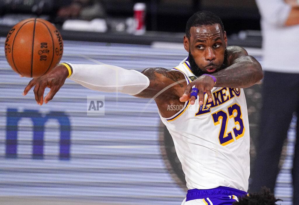 Mark J. Terrill FILE - In this Oct. 4, 2020, file photo, Los Angeles Lakers' LeBron James (23) passes the ball against Miami Heat during the first half in Game 3 of basketball's NBA Finals in Lake Buena Vista, Fla. James was announced Saturday, Dec. 26, as the winner of The Associated Press’ Male Athlete of the Year award for a record-tying fourth time. (AP Photo/Mark J. Terrill, File)