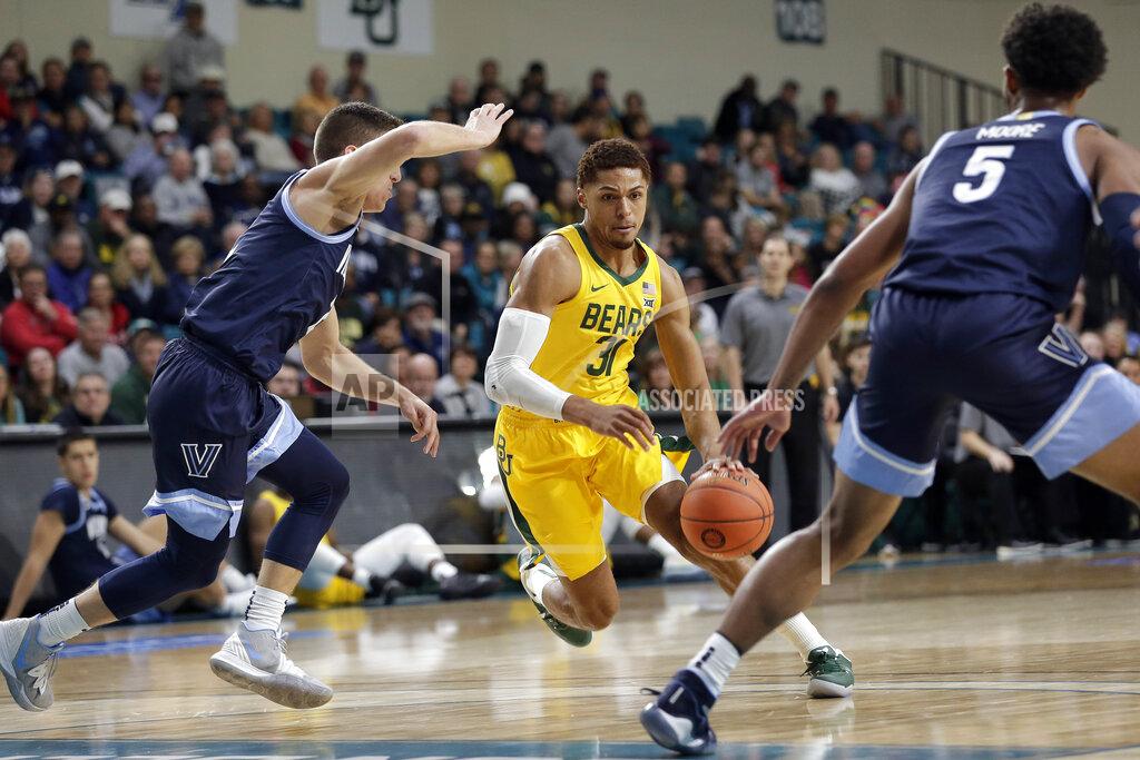 Gerry Broome Baylor guard MaCio Teague (31) drives between Villanova guards Collin Gillespie, left, and Justin Moore (5) during the first half of an NCAA college basketball championship game at the Myrtle Beach Invitational in Conway, S.C., Sunday, Nov. 24, 2019. (AP Photo/Gerry Broome)