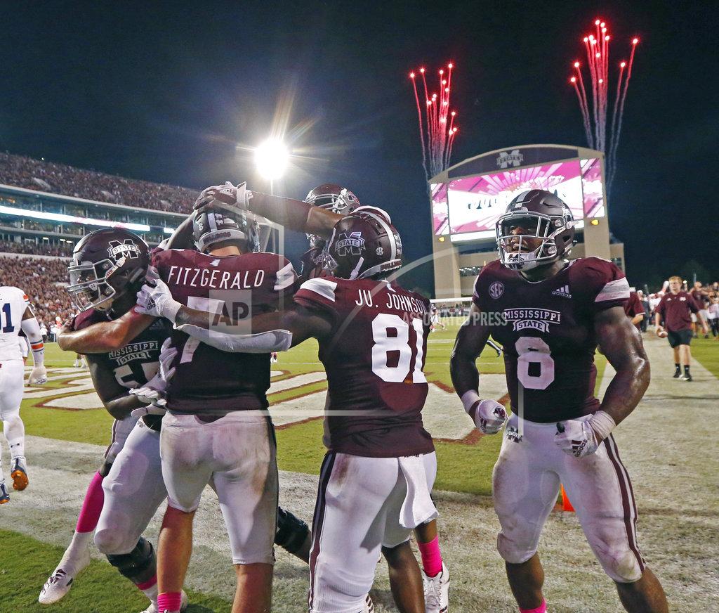 Rogelio V. Solis Mississippi State quarterback Nick Fitzgerald (7) and teammates celebrate his 21-yard touchdown run against Auburn as fireworks go off in the background during an NCAA college football game in Starkville, Miss., Saturday, Oct. 6 2018. Mississippi State won 23-9. (AP Photo/Rogelio V. Solis)
