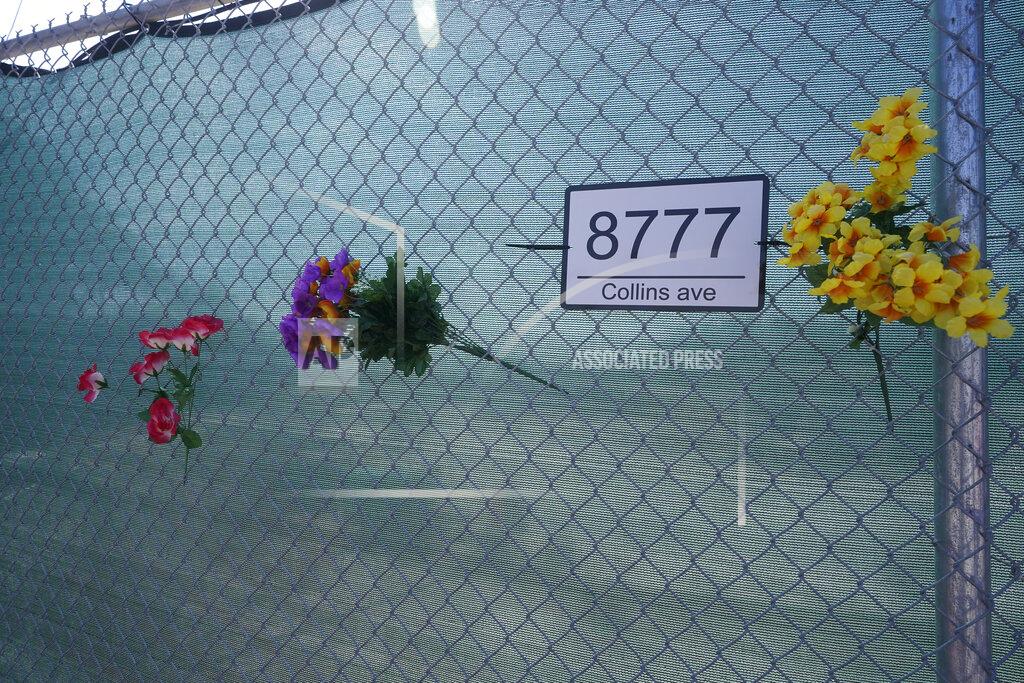 Wilfredo Lee FILE - Artificial flowers are shown on a fence on June 21, 2022, surrounding the site where the Champlain Towers South collapsed killing 98 people last year in Surfside, Fla. A judge has given final approval Thursday, June 23, 2022, to a settlement of more than $1 billion for victims of the collapse of a Florida beachfront condominium. Ninety-eight people died when the 12-story Champlain Towers South suddenly collapsed. The decision comes one day before the one-year anniversary of the disaster in the Miami suburb of Surfside. (AP Photo/Wilfredo Lee, File)