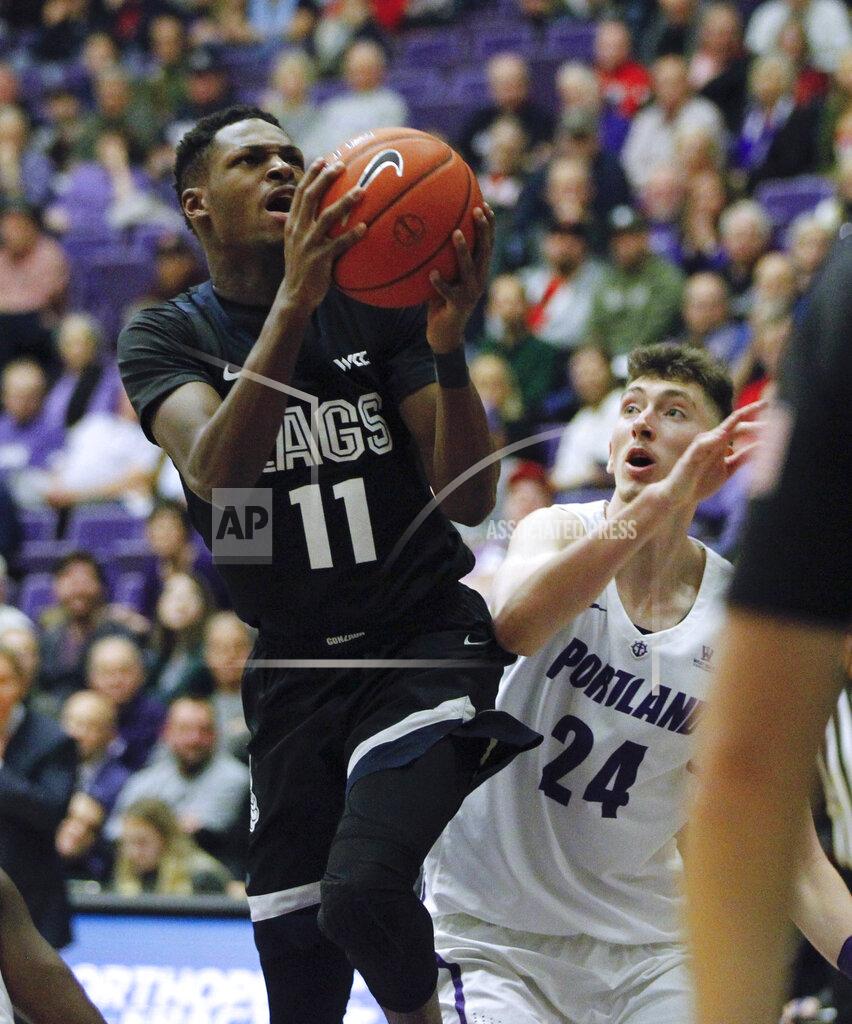 Steve Dipaola Gonzaga guard Joel Ayayi, left, shoots as Portland forward Jacob Tryon defends during the second half of an NCAA college basketball game in Portland, Ore., Thursday, Jan. 2, 2020. Gonzaga won 85-72. (AP Photo/Steve Dipaola)