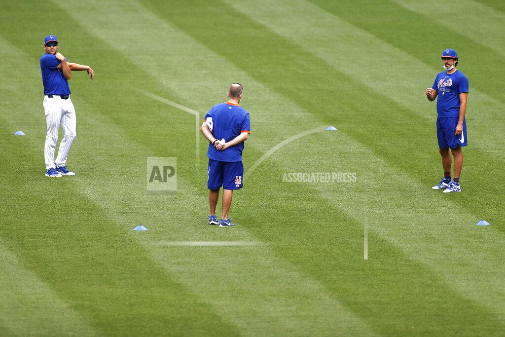 New York Mets pitchers Seth Lugo, left, and Daniel Zamora, right, stretch during a baseball workout at Citi Field in New York, Friday, July 3, 2020. (AP Photo/Adam Hunger)