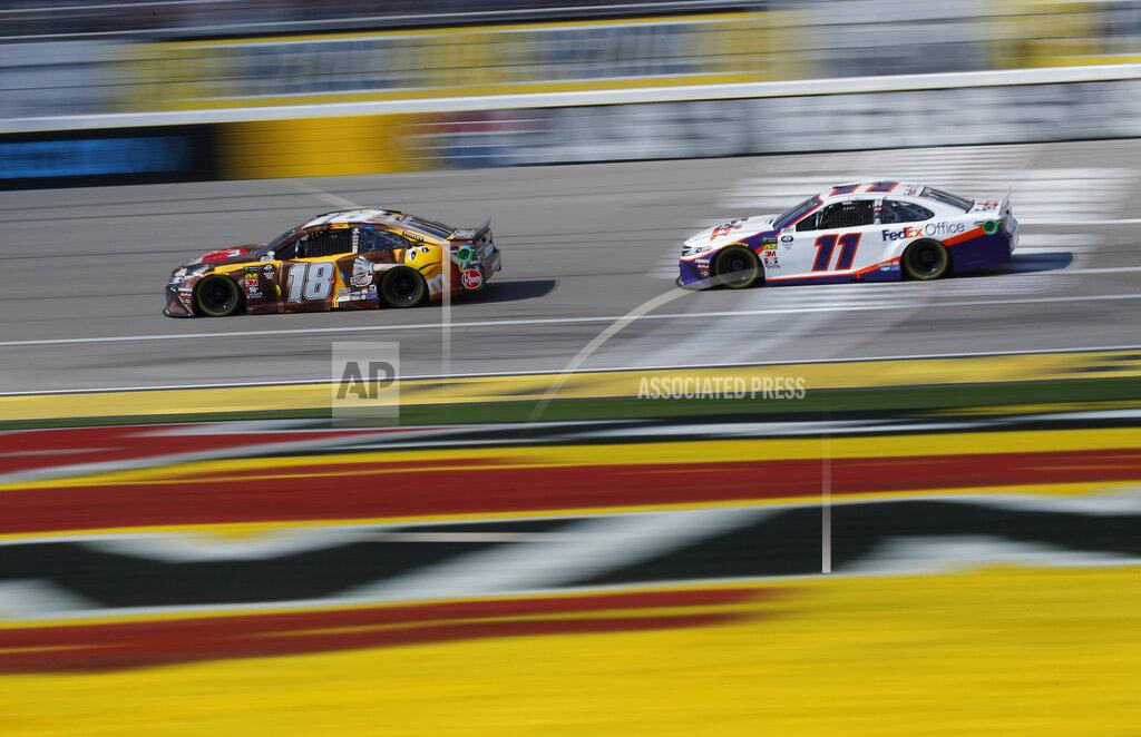 John Locher Kyle Busch (18) and Denny Hamlin (11) drive during a NASCAR Cup Series auto race at Las Vegas Motor Speedway, Sunday, March 3, 2019, in Las Vegas. (AP Photo/John Locher)