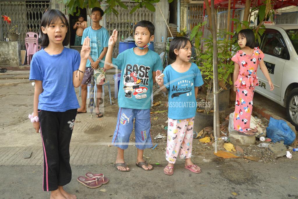 Uncredited Children flash the three-fingered symbol of resistance as they join an anti-coup protest in Yangon, Myanmar, Saturday, April 10, 2021. Security forces in Myanmar cracked down heavily again on anti-coup protesters Friday even as the military downplayed reports of state violence.(AP Photo)