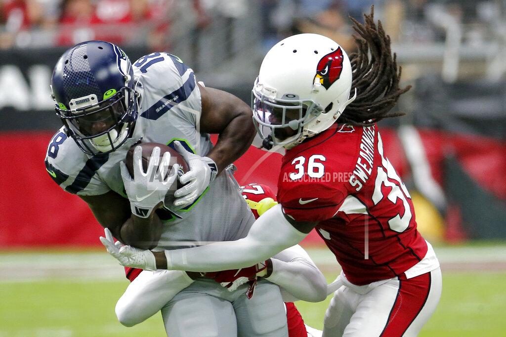 Rick Scuteri Arizona Cardinals free safety D.J. Swearinger (36) tackles Seattle Seahawks wide receiver Jaron Brown (18) during the first half of an NFL football game, Sunday, Sept. 29, 2019, in Glendale, Ariz. (AP Photo/Rick Scuteri)