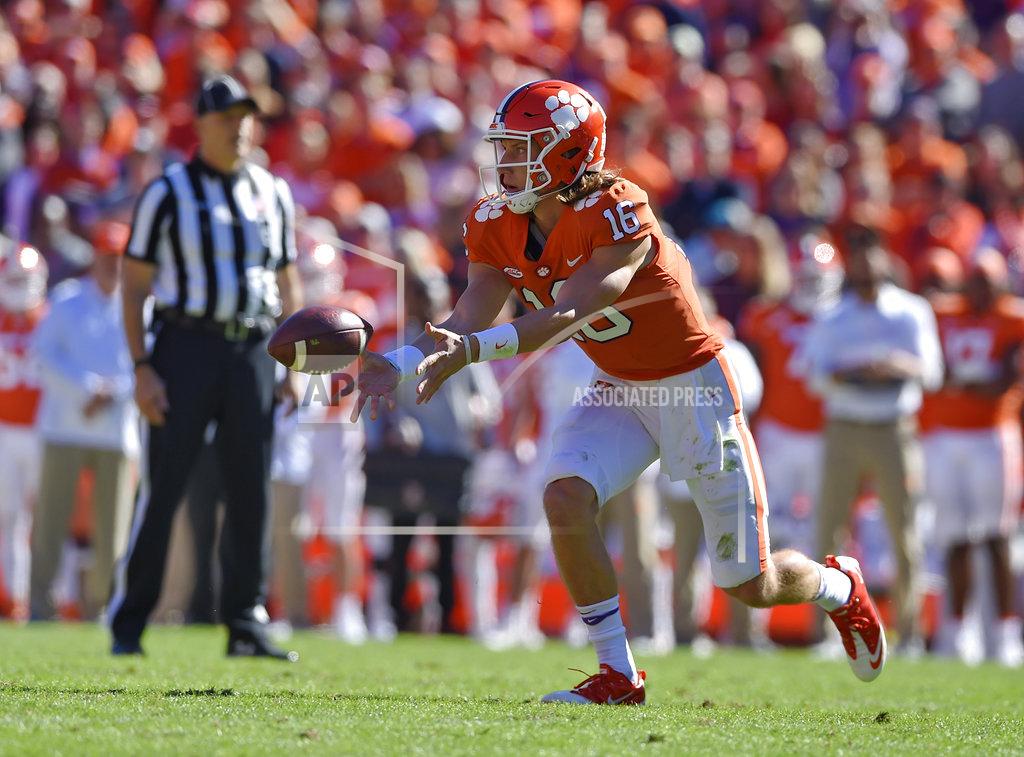 Richard Shiro Clemson quarterback Trevor Lawrence tosses a lateral pass during the first half of an NCAA college football game against Louisville, Saturday, Nov. 3, 2018, in Clemson, S.C. (AP Photo/Richard Shiro)