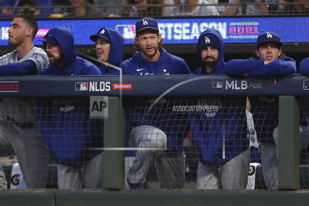 Jed Jacobsohn Injured Los Angeles Dodgers pitcher Clayton Kershaw, middle, stands in the dugout with teammates during the second inning of Game 2 of a baseball National League Division Series against the San Francisco Giants Saturday, Oct. 9, 2021, in San Francisco. (AP Photo/Jed Jacobsohn)
