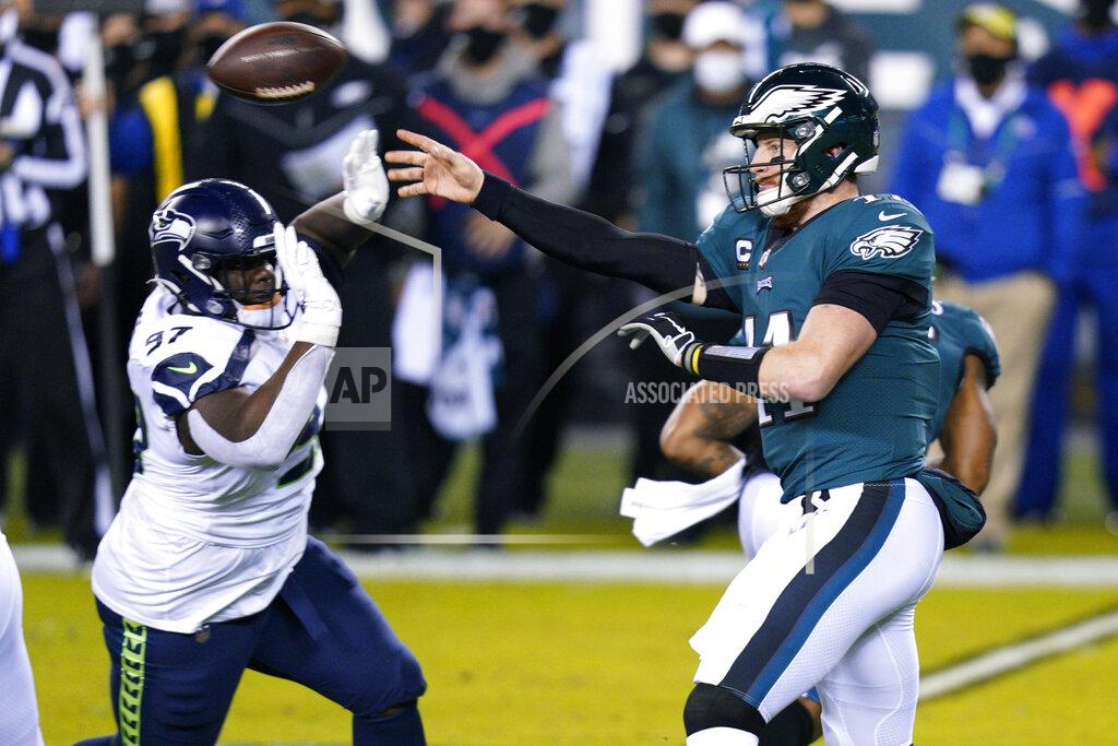 Chris Szagola Philadelphia Eagles' Carson Wentz (11) passes against Seattle Seahawks' Poona Ford (97) during the first half of an NFL football game, Monday, Nov. 30, 2020, in Philadelphia. (AP Photo/Chris Szagola)