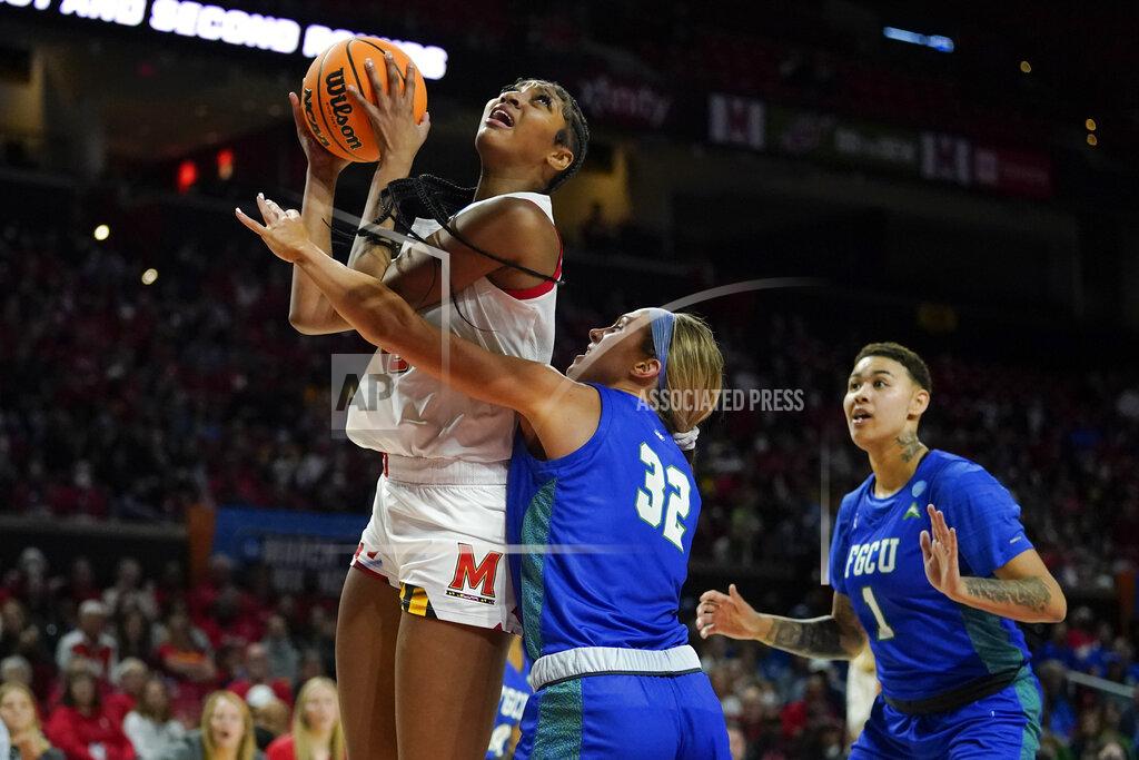 Julio Cortez Maryland forward Angel Reese, left, goes up for a shot against Florida Gulf Coast guard Emma List (32) and guard Kierstan Bell (1) during the second half of a college basketball game in the second round of the NCAA tournament, Sunday, March 20, 2022, in College Park, Md. Maryland won 89-65. (AP Photo/Julio Cortez)