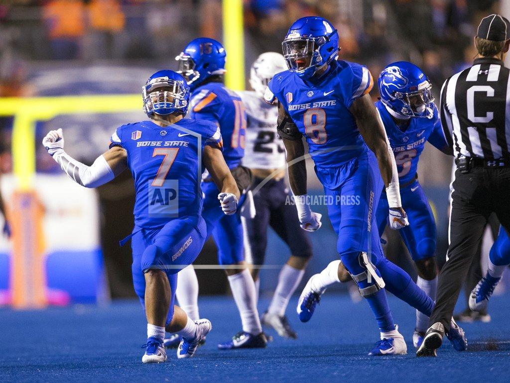 Darin Oswald Boise State linebackers Ezekiel Noa (7) and Jabril Frazier (8) celebrate stopping Utah State on a fake punt during the first half of an NCAA college football game Saturday, Nov. 24, 2018, in Boise, Idaho. (Darin Oswald/Idaho Statesman via AP)