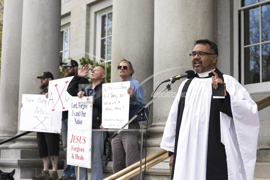 Geoff Forester Reverend Christian Canon Tutor, right, of All Saints Anglican Church speaks to a crowd of people from the State House steps on Saturday, May 16, 2020 in Concord, N.H. (Geoff Forester/The Concord Monitor via AP)