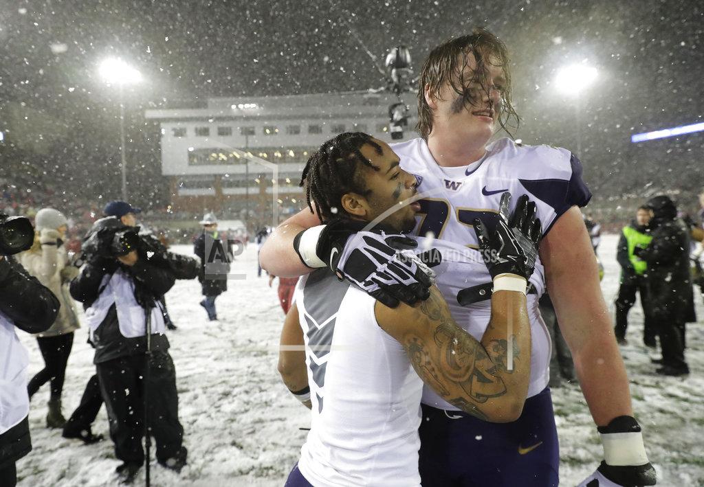 Ted S. Warren Washington running back Myles Gaskin, left, celebrates with offensive lineman Trey Adams after Washington defeated Washington State 28-15 in an NCAA college football game Friday, Nov. 23, 2018, in Pullman, Wash. (AP Photo/Ted S. Warren)