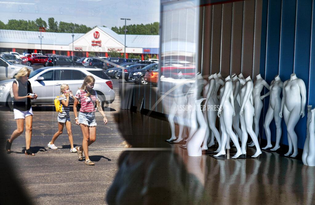 David Goldman Mannequins stand in an empty store as shoppers visit outlet shops in Oshkosh, Wis., part of the greater Appleton area, Aug. 20, 2020. Storefronts after the pandemic have been emptied at the Oshkosh Outlets, including the nearby Brooks Brothers, the haberdashery for generations of presidents, that filed for bankruptcy this year. (AP Photo/David Goldman)