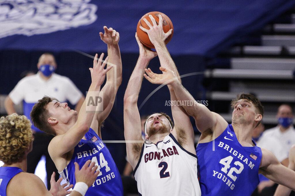 Young Kwak Gonzaga forward Drew Timme (2) grabs a rebound between BYU guard Connor Harding (44) and center Richard Harward (42) during the first half of an NCAA college basketball game in Spokane, Wash., Thursday, Jan. 7, 2021. (AP Photo/Young Kwak)