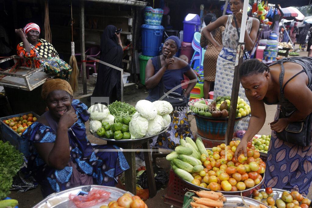 Sunday Alamba Women sell vegetables at Kaporo market in Conakry, Guinea Monday, Sept. 13, 2021. Guinea's longtime opposition leader says he welcomes the coup that deposed President Alpha Conde. But Cellou Dalein Diallo is calling on the junta leaders to create a transitional government and a timeline for elections as soon as possible. (AP Photo/Sunday Alamba)