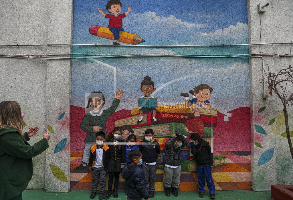 Esteban Felix Students take a break at school where in-person classes have restarted for a second time this academic year amid the COVID-19 pandemic in Santiago, Chile, Monday, July 26, 2021. The capital has ended weekend quarantines and are allowing more people inside restaurants gyms and returning public school students to in-person classes with gradual and voluntary attendance. (AP Photo/Esteban Felix)