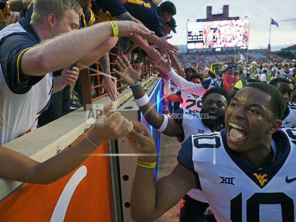 Michael Thomas West VirginiaTrey Love, III celebrates with West Virginia fans after defeating Texas in an NCAA college football game, Saturday, Nov. 3, 2018, in Austin, Texas. West Virginia won 42-41. (AP Photo/Michael Thomas)