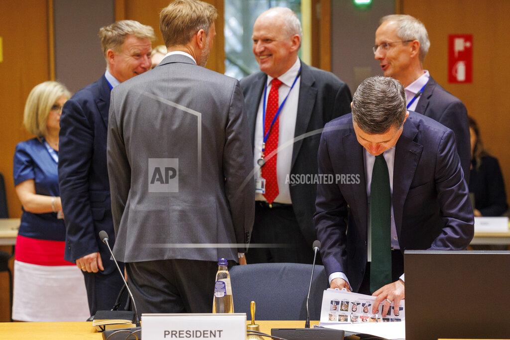 Olivier Matthys Ireland's Finance minister and President of the Eurogroup Paschal Donohoe, right, checks his list of participants prior to chairing the meeting of Eurogroup Finance Ministers at the European Council building in Brussels, Monday, May 23, 2022. (AP Photo/Olivier Matthys)