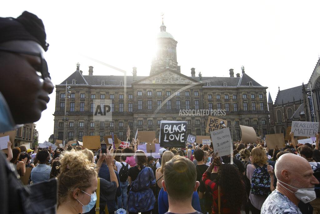 Peter Dejong People take part in a Black Lives Matter protest in front of the Royal Palace on Dam Square in Amsterdam, Netherlands, Monday, June 1, 2020, to protest against the recent killing of George Floyd, a black man who died in police custody in Minneapolis, U.S.A., after being restrained by police officers on Memorial Day. (AP Photo/Peter Dejong)